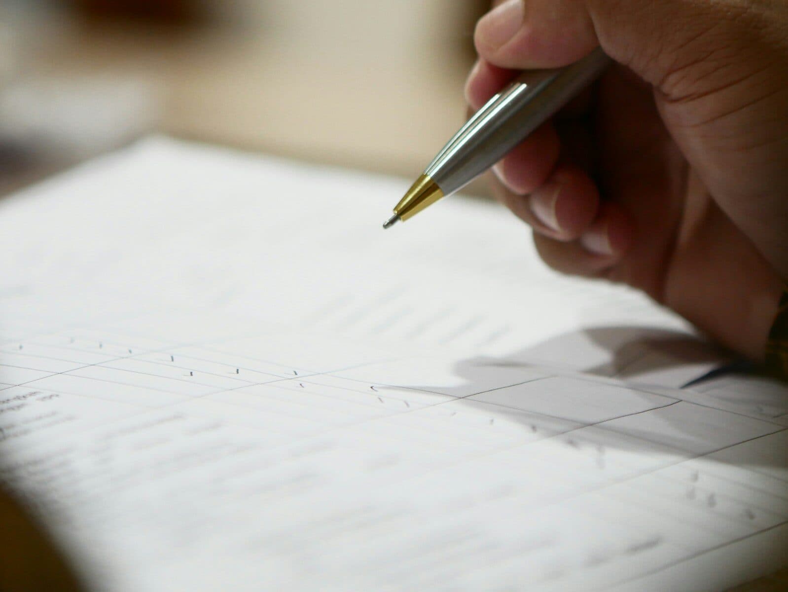 a hand holding a pen